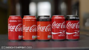 Different cans of Coca-Cola, with a slightly different red